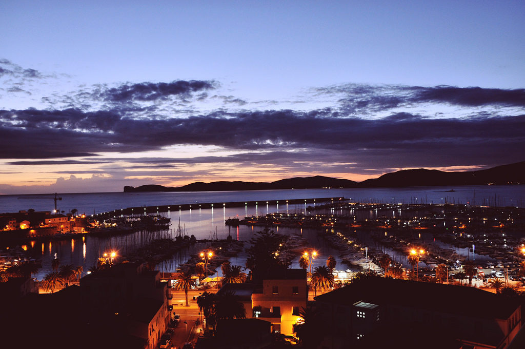 pictures of Alghero Italy Sardinia by night in an article about travel tips