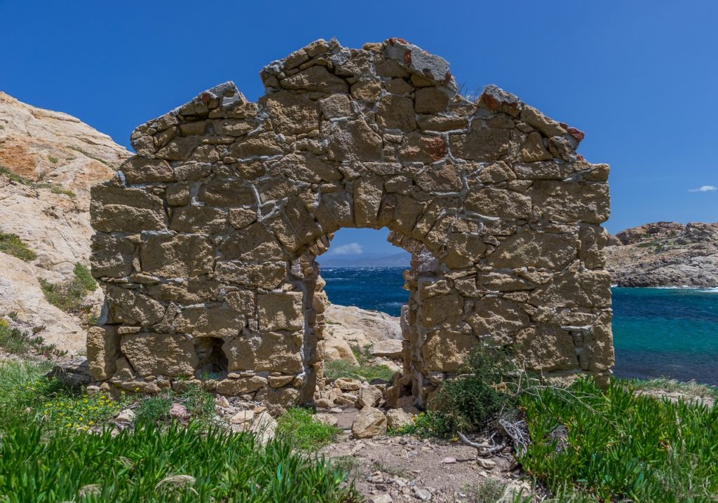 ancient door make of rocks on sardinian coast